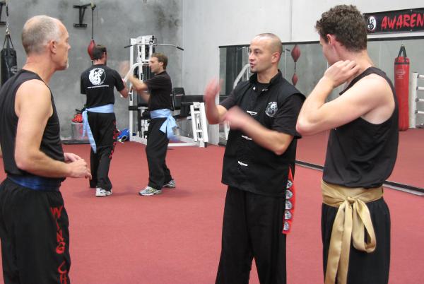 Adults receiving Wing Chun instruction in class