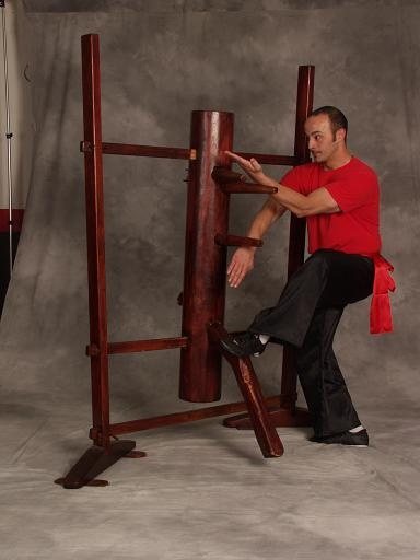 Joe Sayah demonstrating a Wing Chun movement on a wooden dummy