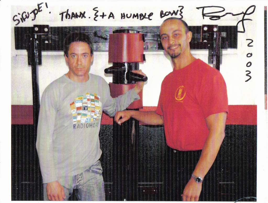 Signed 2003 photograph of Robert Downey Jr and Joe Sayah beside a wooden dummy