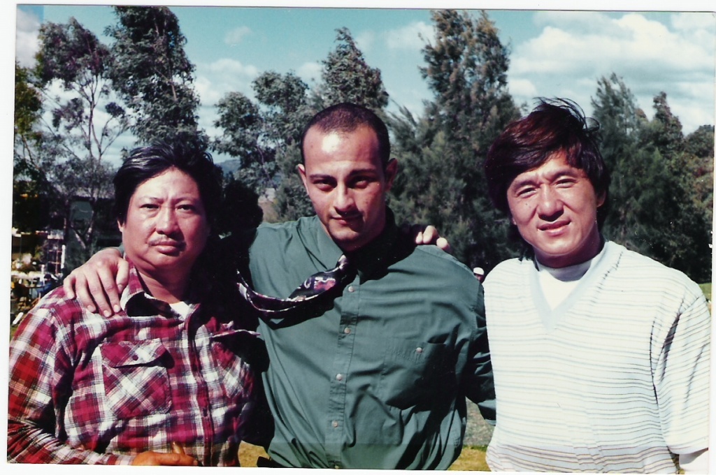 Sammo Hung, Joe Sayah and Jackie Chan together outdoors during a Melbourne film production