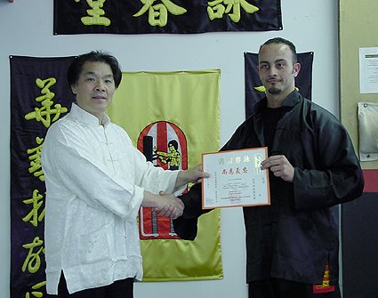 Grandmaster William Cheung presenting a certificate to Joe Sayah in April 2001