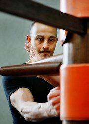 Joe Sayah practising Wing Chun movements on a wooden dummy